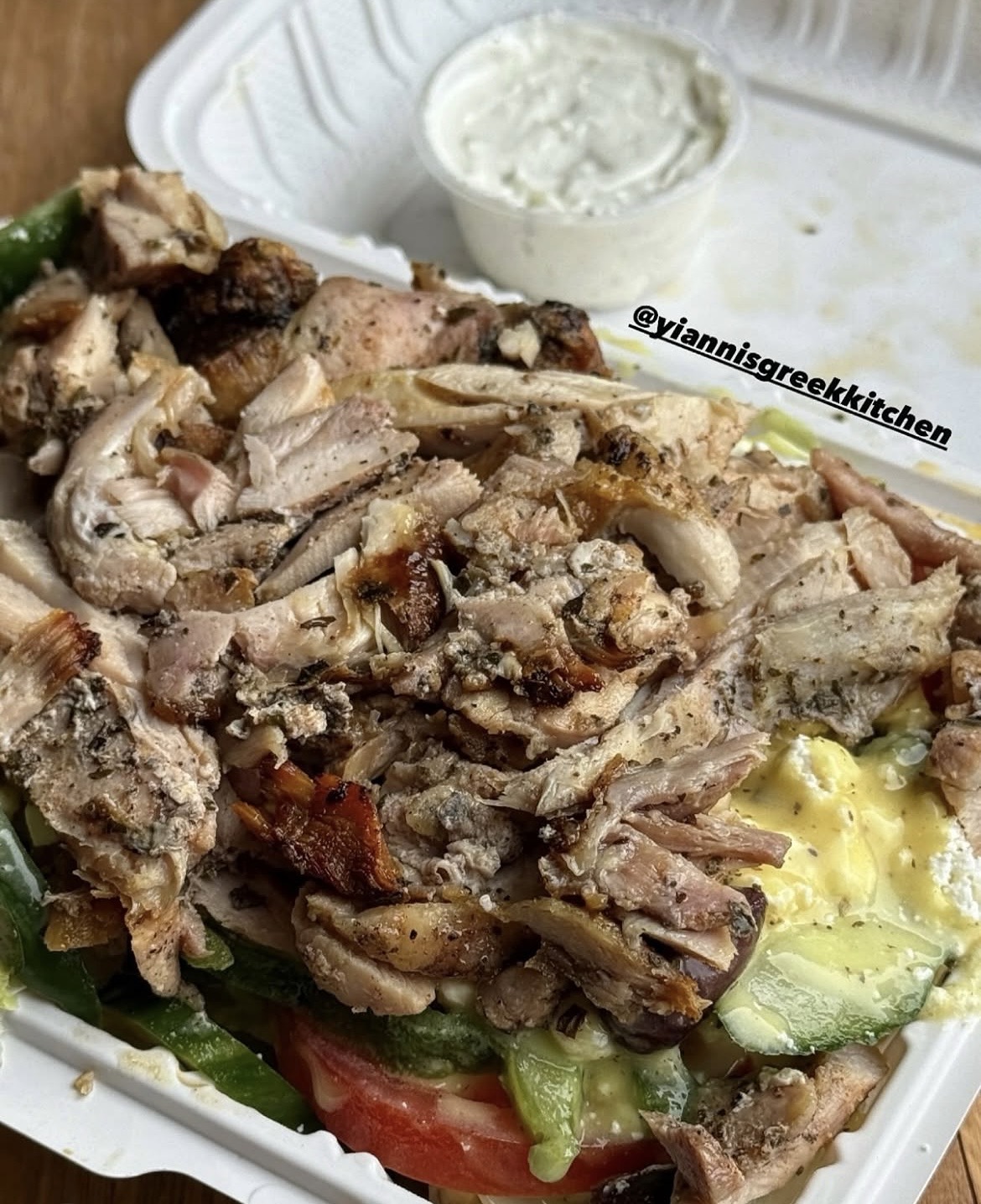 Chicken Greek salad with tzatziki in a takeout box